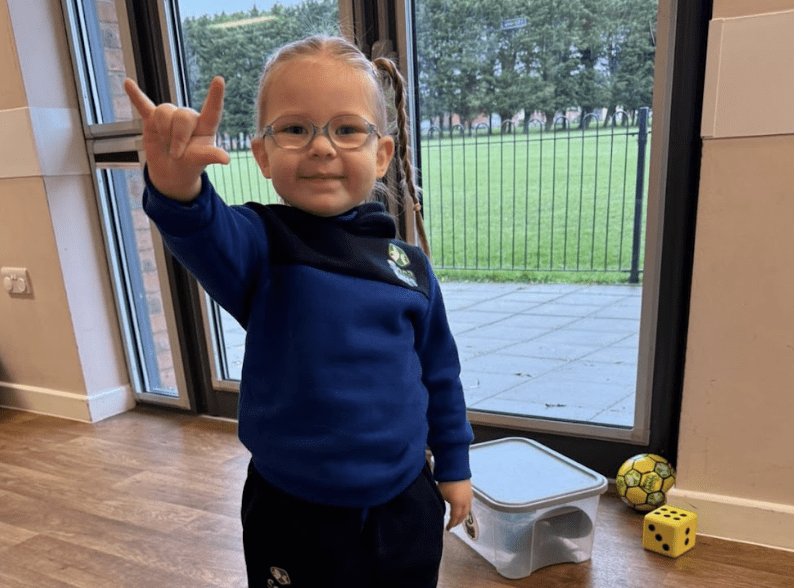 Signs your toddler is ready for a football class. Image shows a girl in a Socatots uniform.
