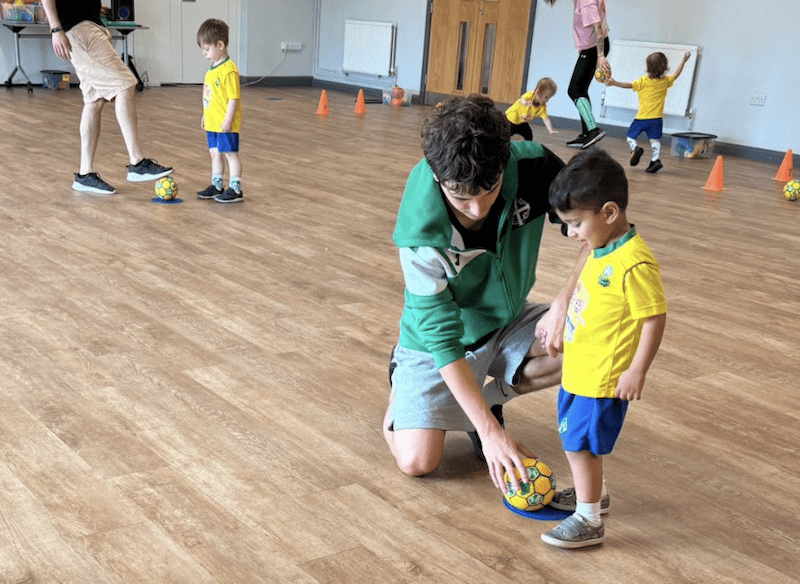 Toddler groups near me. Image shows toddlers and parents taking part in a Socatots class